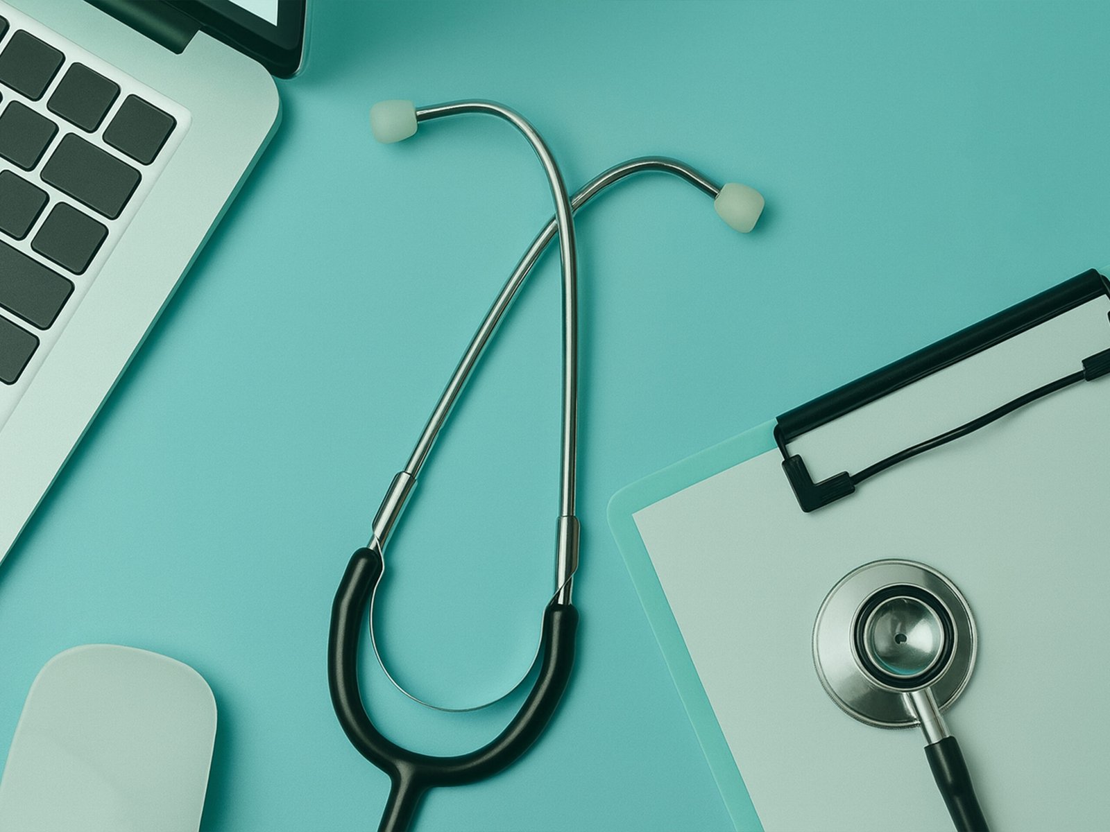 At the online health care doctor's room, a laptop and a stethoscope